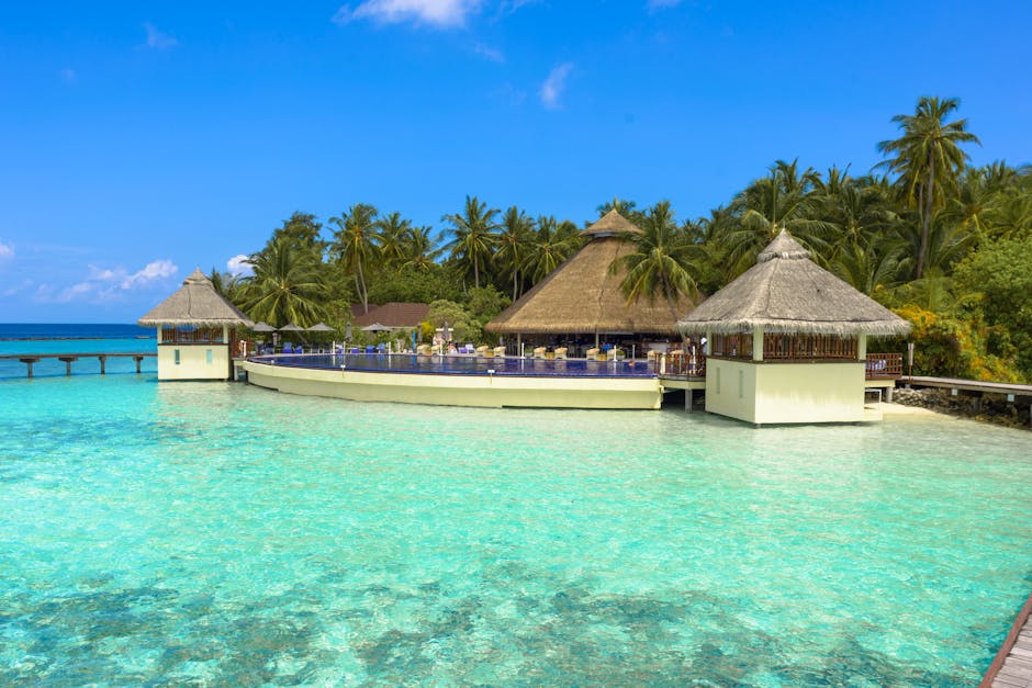 Stunning tropical beach resort with bungalows over turquoise waters, perfect for a relaxing getaway.