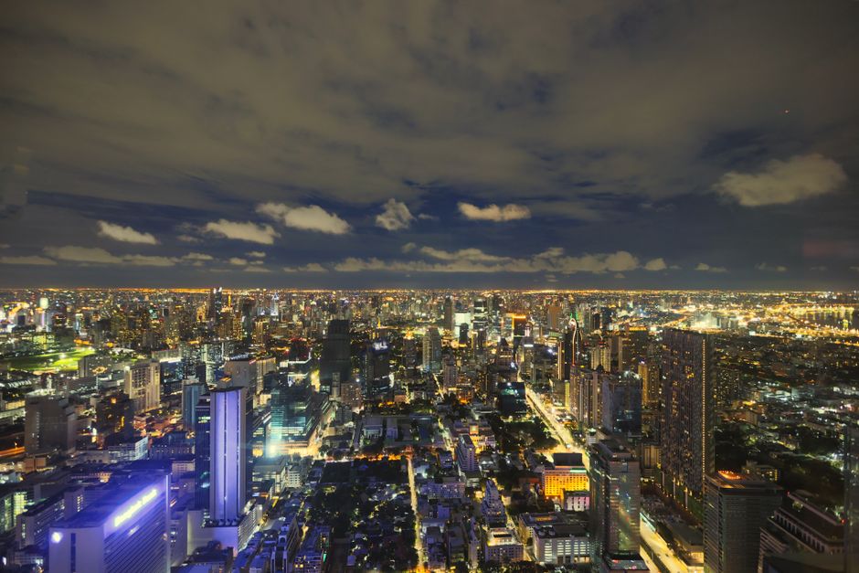 A captivating view of Bangkok's illuminated skyline at night, showcasing its modern architecture.