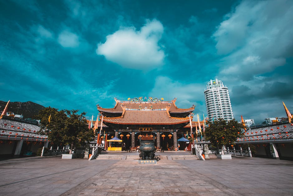 Majestic Asian temple with intricate architecture under vibrant blue sky. Perfect travel destination.