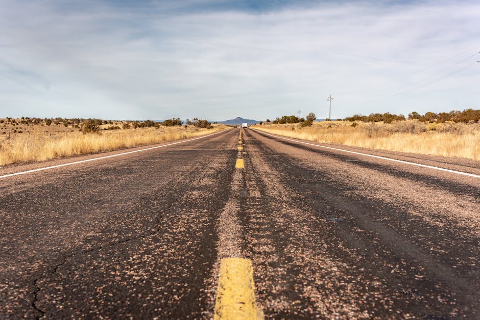 Long desert highway stretching into the horizon in Arizona, USA.