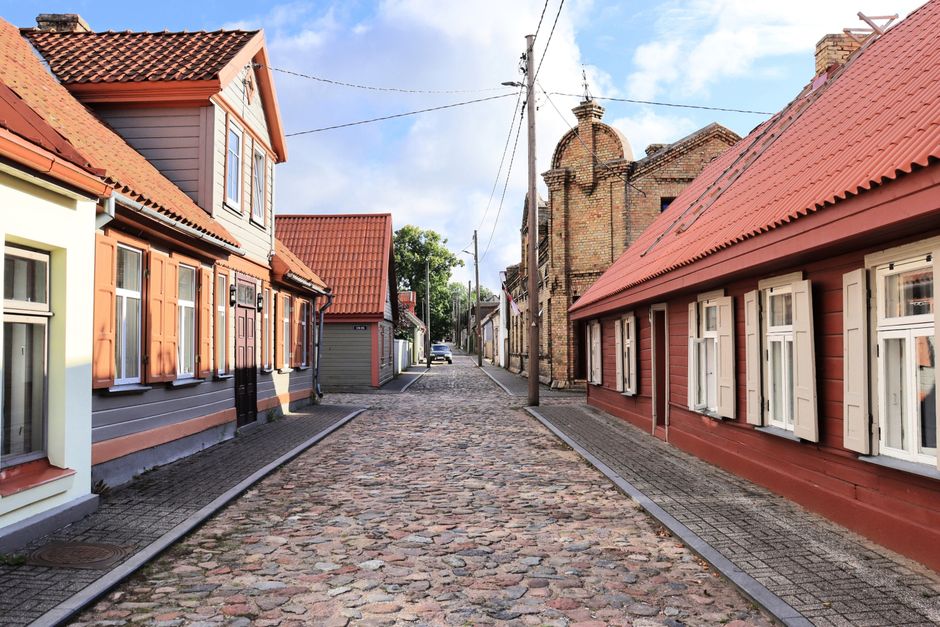 Cobblestone old town street with wooden houses on a Baltic summer evening