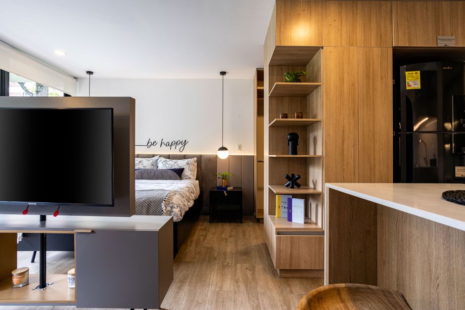 Cozy and stylish studio apartment interior design in Bogotá with wooden accents.