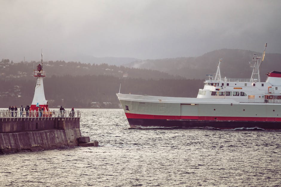A ferry approaches a breakwater with a lighthouse in Victoria, British Columbia.