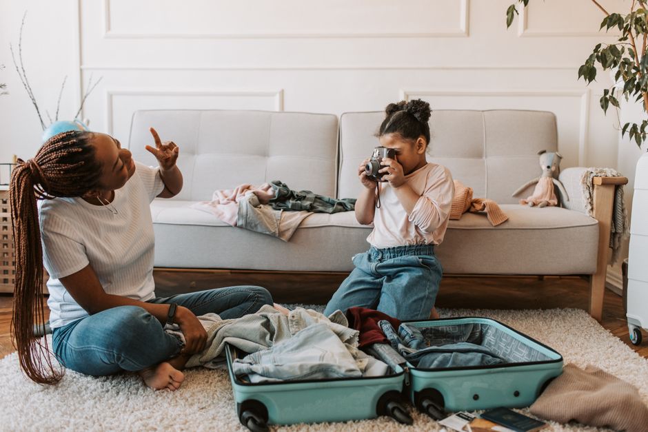 Mother and daughter packing a suitcase for a February half-term trip