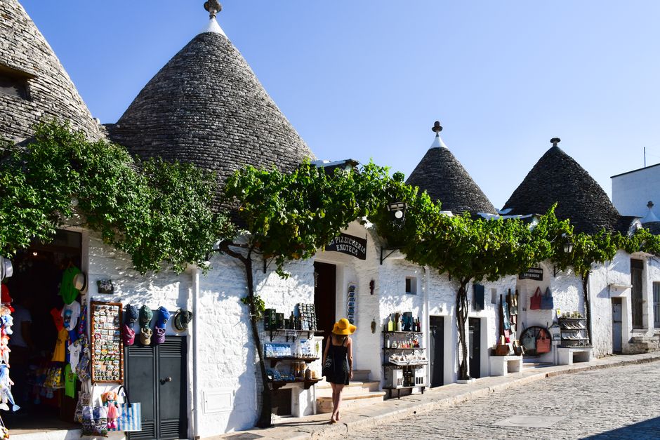 Scenic view of Trulli houses in Alberobello, Apulia, Italy, under a clear sky.