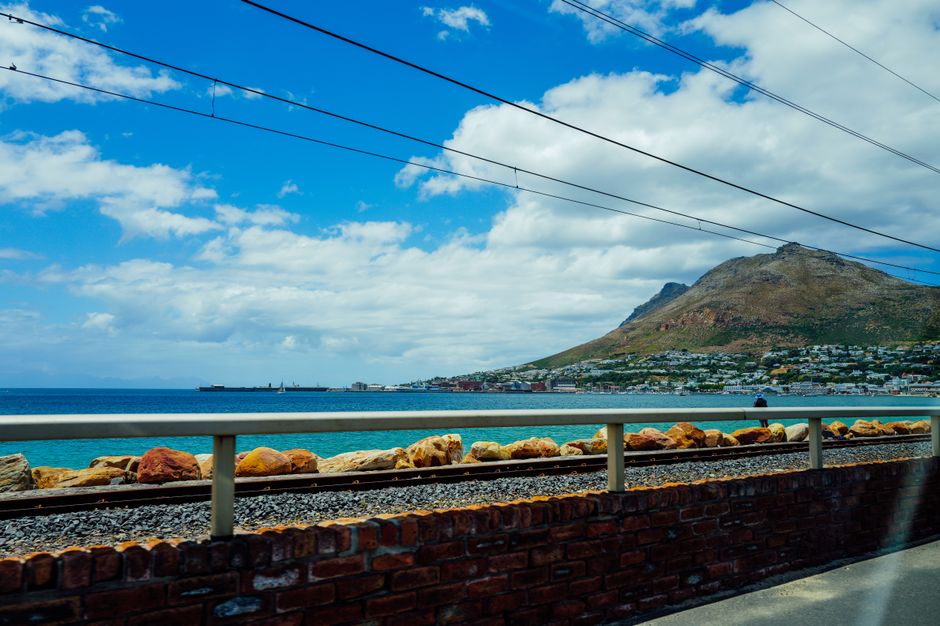 Beautiful coastal view with a mountain backdrop under a clear sky. Perfect for travel content.