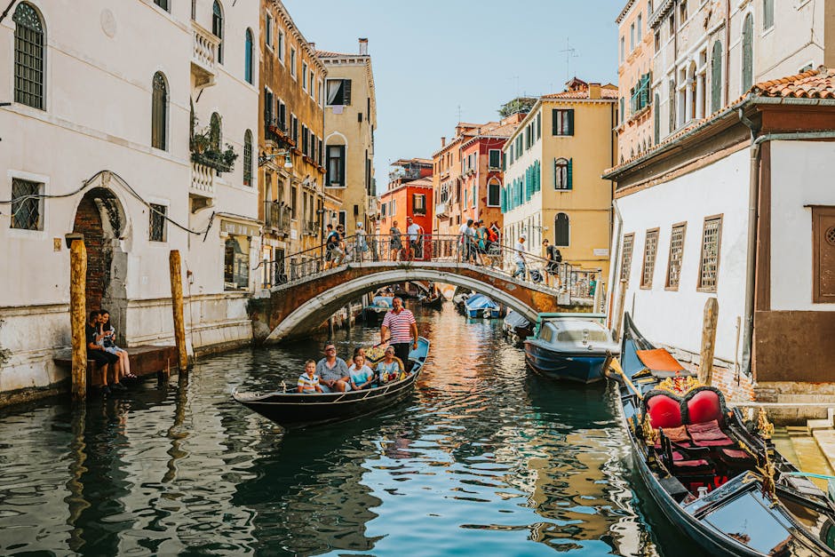 Explore Venice's charming canals with gondolas and historic architecture under a bright day.