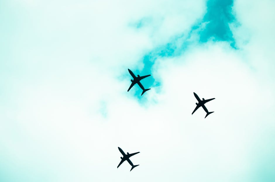 Silhouetted airplanes flying in formation against a bright sky. Captures the essence of aviation.